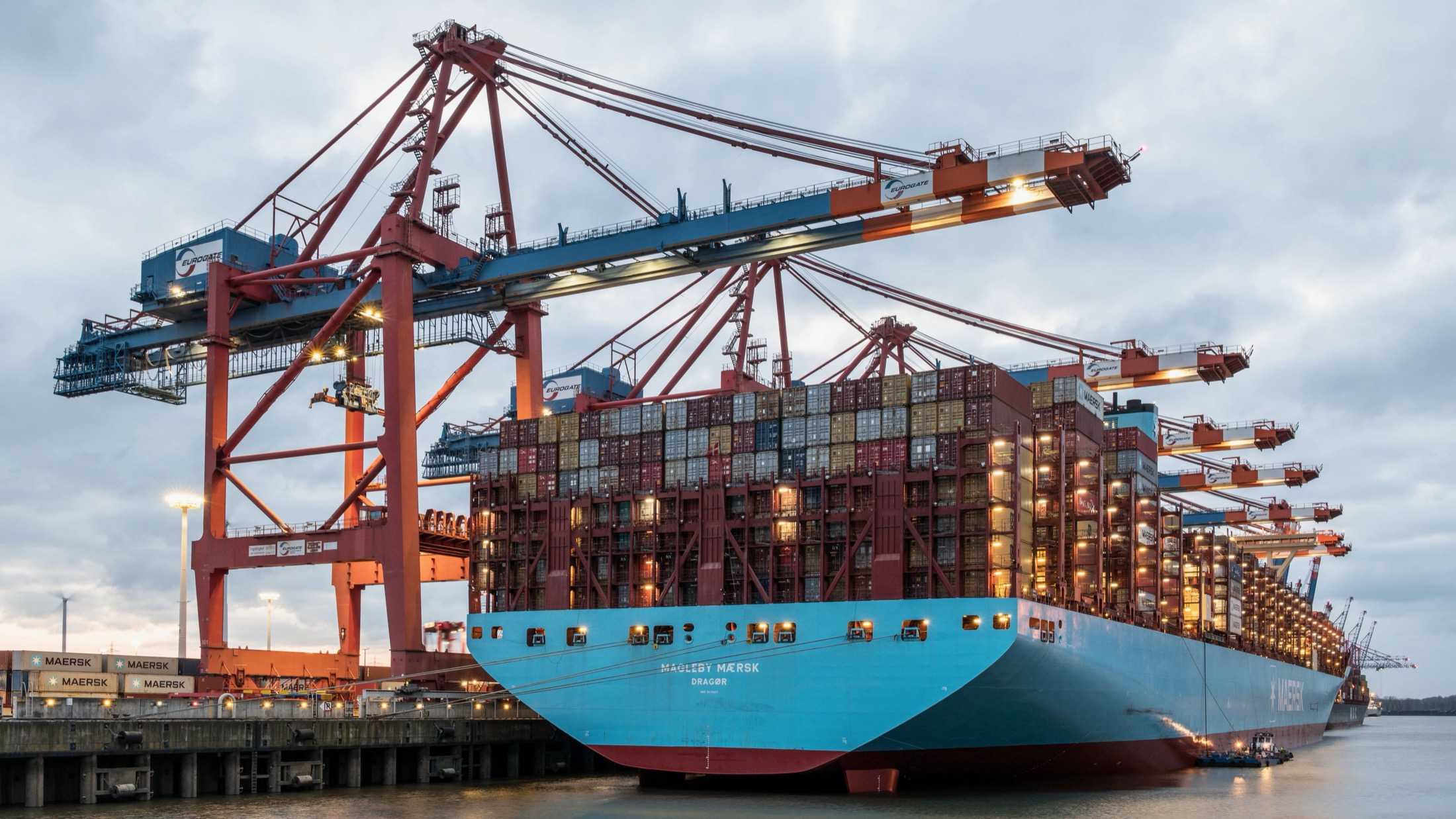 Container vessel alongside port cranes